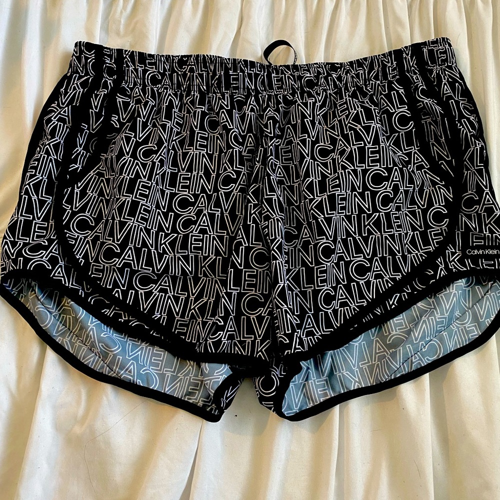 Black and white Calvin Klein logo running shorts.